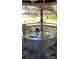 Relaxing screened porch with a table, chairs, and views of the surrounding nature at 1717 Se 190Th Ave, Silver Springs, FL 34488