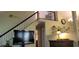 Elegant staircase with decorative lighting, complemented by stylish wall decor and a spacious layout at 1717 Se 190Th Ave, Silver Springs, FL 34488