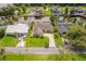 Stunning aerial view of waterfront home with lush landscaping, private dock, and beautiful curb appeal at 1721 Perch Ln, Sanford, FL 32771