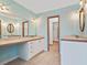 Bathroom with a long, marble-style countertop and large mirror, with access to the walk-in closet at 1721 Perch Ln, Sanford, FL 32771