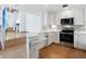 Updated kitchen featuring white cabinets, stainless steel appliances, breakfast bar, and tile floors at 1721 Perch Ln, Sanford, FL 32771
