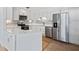 Well-equipped kitchen with white cabinets, stainless steel appliances, and an island with a breakfast bar at 1721 Perch Ln, Sanford, FL 32771