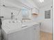 Bright laundry room featuring a washer, dryer, storage shelves, countertop, and window at 1721 Perch Ln, Sanford, FL 32771
