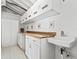 Bright laundry room featuring a sink, cabinetry, countertop, and utility storage at 1721 Perch Ln, Sanford, FL 32771
