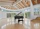 Bright living room with high ceilings, large windows, tile flooring, and a grand piano, creating a stunning focal point at 1721 Perch Ln, Sanford, FL 32771