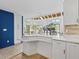 Bright open living space with tiled floors, piano, and kitchen counter access, perfect for entertaining at 1721 Perch Ln, Sanford, FL 32771