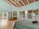 Serene main bedroom with vaulted ceiling, light wood floors, and access to a private balcony at 1721 Perch Ln, Sanford, FL 32771