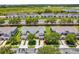 Beautiful aerial view of townhomes with manicured lawns, mature trees, and a scenic view of a lake at 1784 Fritwell Ct, Ocoee, FL 34761