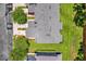 Aerial view of gray roof and community landscaping featuring manicured lawn and mature trees at 1784 Fritwell Ct, Ocoee, FL 34761