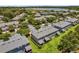 Aerial view of the townhouse community featuring lush landscaping, water views, and updated exteriors at 1784 Fritwell Ct, Ocoee, FL 34761