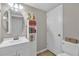 Cozy bathroom with tiled floors, decorative mirror, and a functional toilet at 1784 Fritwell Ct, Ocoee, FL 34761