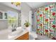 Bathroom with shower and tub, large mirror, and bright natural light at 1784 Fritwell Ct, Ocoee, FL 34761