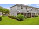 Well-maintained townhouse features a large lawn, trimmed shrubs, and screened in back patio at 1784 Fritwell Ct, Ocoee, FL 34761