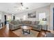 Spacious living room featuring a large sectional sofa and hardwood flooring at 1784 Fritwell Ct, Ocoee, FL 34761