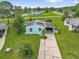 Aerial view of a charming single-Gathering home with a lush green yard in a serene neighborhood setting at 222 Ellsworth Dr, Kissimmee, FL 34758