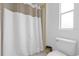 Bathroom featuring tiled floors, a white toilet, and a shower with a simple white curtain at 222 Ellsworth Dr, Kissimmee, FL 34758