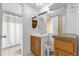 Bathroom featuring an ornate mirror, a wooden vanity, and a shower with a simple curtain at 222 Ellsworth Dr, Kissimmee, FL 34758