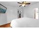 Bright bedroom featuring hardwood floors, a ceiling fan, and neutral decor with a doorway to other rooms at 222 Ellsworth Dr, Kissimmee, FL 34758