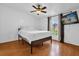 Bedroom featuring hardwood floors, a ceiling fan, and natural light from the window with the television on the wall at 222 Ellsworth Dr, Kissimmee, FL 34758