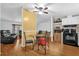 Cozy dining area open to the living room, with stylish furnishings and hardwood flooring at 222 Ellsworth Dr, Kissimmee, FL 34758