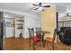 Dining area next to living room with hardwood flooring and laundry in the background at 222 Ellsworth Dr, Kissimmee, FL 34758