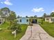 Charming light blue single-story home with a long driveway and well-maintained lawn at 222 Ellsworth Dr, Kissimmee, FL 34758