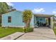 Charming home featuring light blue siding, carport, and lush green lawn at 222 Ellsworth Dr, Kissimmee, FL 34758
