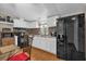 Well-lit kitchen with white cabinets, tiled backsplash, and black appliances at 222 Ellsworth Dr, Kissimmee, FL 34758