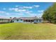 Home with a screened lanai and a large green lawn at 2290 Carson Ln, Deltona, FL 32738