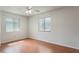 Bright bedroom featuring two windows with blinds and a ceiling fan with light fixture at 2290 Carson Ln, Deltona, FL 32738