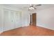 Bedroom with double closet doors, ceiling fan, and laminate flooring at 2290 Carson Ln, Deltona, FL 32738