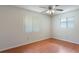 Bedroom with two windows, ceiling fan, and laminate flooring at 2290 Carson Ln, Deltona, FL 32738