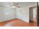 Bedroom with double closet doors, ceiling fan, laminate flooring, and access to another room at 2290 Carson Ln, Deltona, FL 32738