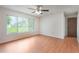 Bedroom with ceiling fan, laminate flooring, and window overlooking backyard at 2290 Carson Ln, Deltona, FL 32738
