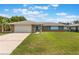 Lovely house with an attached garage and a well-kept lawn at 2290 Carson Ln, Deltona, FL 32738