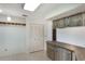 Kitchen space with stainless steel dishwasher, wood-look cabinets, and bi-fold door access at 2290 Carson Ln, Deltona, FL 32738