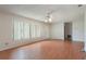 Bright living room with wood-look floors, a ceiling fan, and a large window at 2290 Carson Ln, Deltona, FL 32738