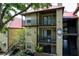Condo building with red roof, covered walkways, and balconies, surrounded by green landscaping and mature trees at 234 Afton Sq # 205, Altamonte Springs, FL 32714