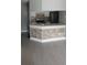 Kitchen featuring decorative tile backsplash, white cabinetry, stainless steel appliances, and breakfast bar at 234 Afton Sq # 205, Altamonte Springs, FL 32714
