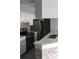 Kitchen featuring decorative tile backsplash, white cabinetry, stainless steel appliances, and breakfast bar at 234 Afton Sq # 205, Altamonte Springs, FL 32714
