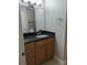 Bathroom showcases vanity with dark countertop and wood cabinets at 236 Afton Sq # 309, Altamonte Springs, FL 32714