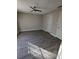 Spacious bedroom with modern ceiling fan, gray walls, and beautiful gray wood flooring at 236 Afton Sq # 309, Altamonte Springs, FL 32714