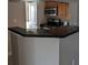The breakfast bar features sleek, dark countertops and modern appliances for casual dining at 236 Afton Sq # 309, Altamonte Springs, FL 32714