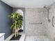 Accessible shower room with tiled walls and safety bars at 244 Surf Scooter Dr, Daytona Beach, FL 32119