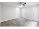 Clean bedroom with carpeted floor, ceiling fan and a door to outside at 244 Surf Scooter Dr, Daytona Beach, FL 32119