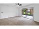 Large bedroom with carpet and sliding glass door to outside at 244 Surf Scooter Dr, Daytona Beach, FL 32119