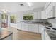 Bright kitchen with white cabinets, modern countertops, and stainless steel appliances at 244 Surf Scooter Dr, Daytona Beach, FL 32119