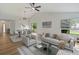 Bright living room with vaulted ceiling, ceiling fan, and dining area at 244 Surf Scooter Dr, Daytona Beach, FL 32119