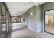 Screened porch with tiled floors and ceiling fans, perfect for outdoor relaxation at 244 Surf Scooter Dr, Daytona Beach, FL 32119