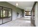 Spacious sunroom with tiled floors and access to the outdoors through sliding glass doors at 244 Surf Scooter Dr, Daytona Beach, FL 32119